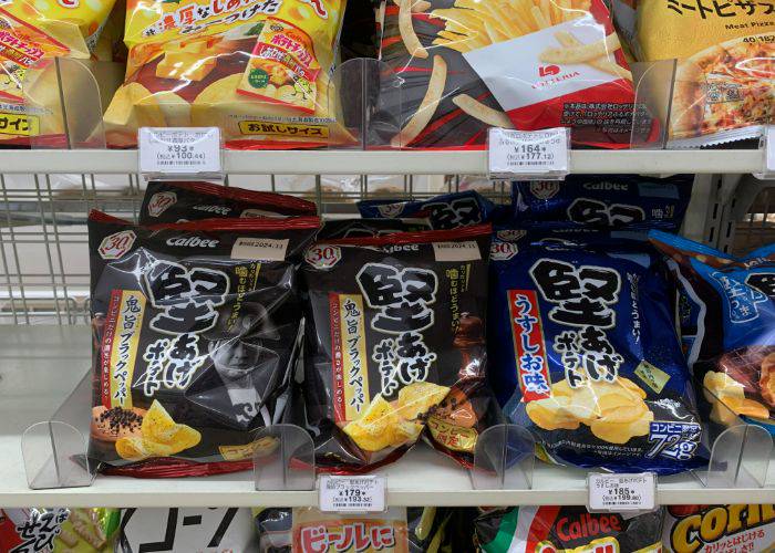 A selection of chips on a shelf at the konbini, featuring the kataage potato variety mentioned in this blog.
